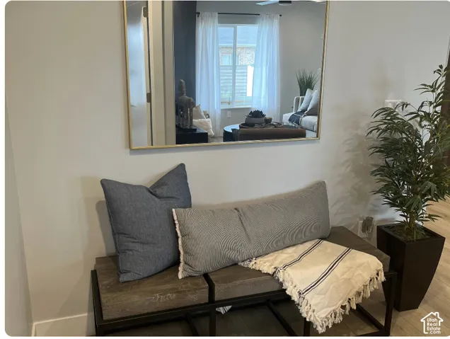 Large rectangular mirror with a metallic frame paired with wood-finish flooring