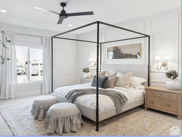 Wall molding detail, matte black ceiling fan, and dual wall-mounted sconces