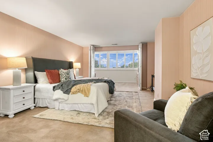 Spacious interior featuring neutral wall coverings, carpeting, and multi-panel plantation shutters