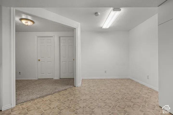 Interior space featuring patterned vinyl flooring, neutral wall finishes, recessed lighting, and two six-panel interior doors