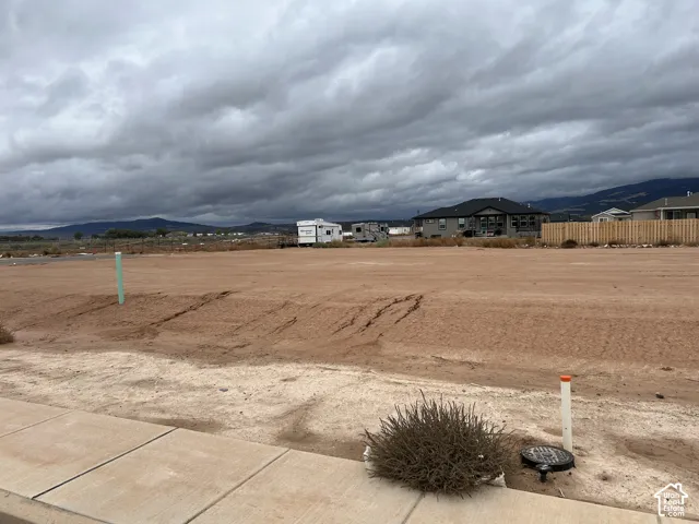 Undeveloped land parcel featuring a cleared, level topography and mountain backdrop