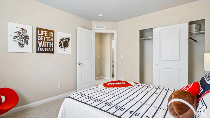 Interior space featuring neutral wall paint, wall-to-wall carpeting, and a dual-panel sliding closet door