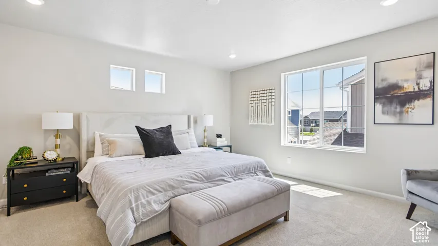 Neutral-toned wall finish, wall-to-wall carpeting, recessed ceiling lighting, and multi-pane windows