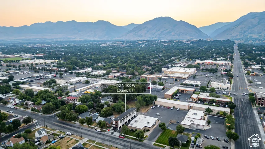 Aerial perspective showcasing a multi-unit residential property set against a mountain backdrop