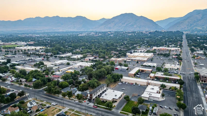 Aerial perspective of a multi-story urban building with mountain range scenery