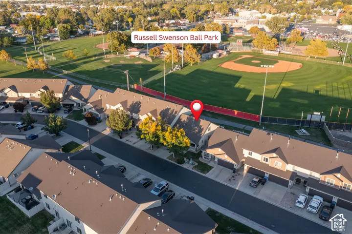 Aerial perspective of multi-family residences featuring attached garages, asphalt driveways, and composition shingle roofing