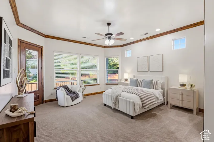 Bedroom featuring crown molding, neutral carpeting, recessed lighting, ceiling fan with integrated light fixture, and glass-paneled exterior door