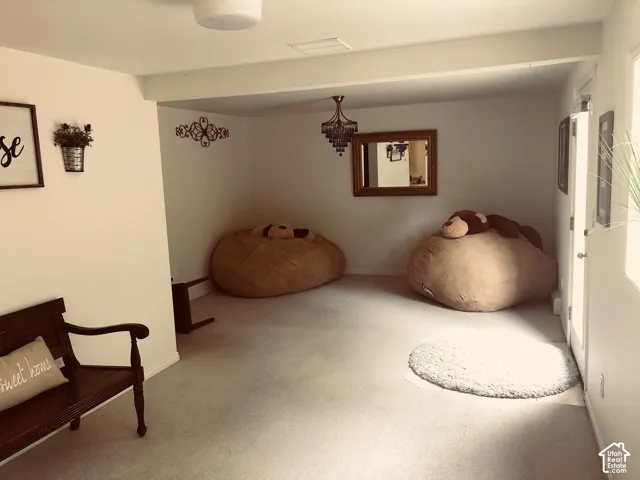 2nd Home. Neutral-toned interior space featuring wall-to-wall carpeting, recessed ceiling lighting, and a multi-tiered decorative pendant fixture