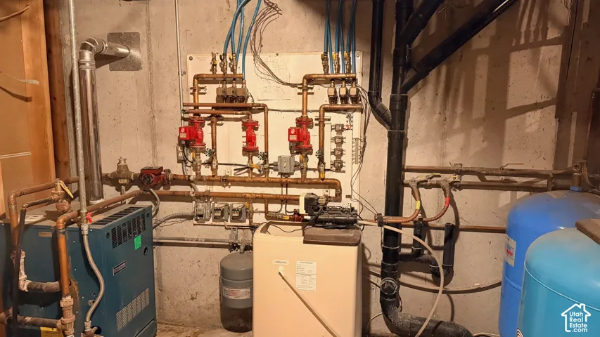 Hydronic heating system featuring a manifold assembly, circulating pumps, and dual pressure tanks