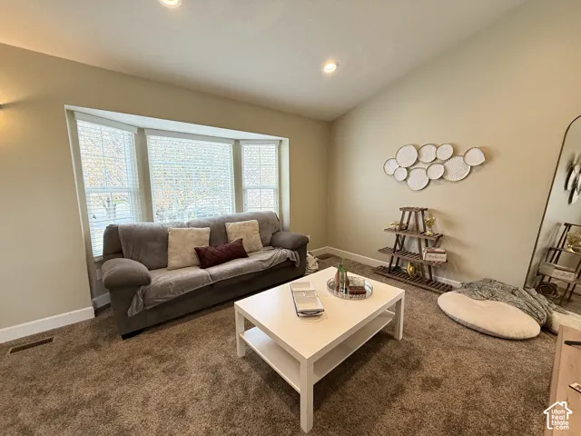 Vaulted ceilings, expansive bay window, and recessed lighting