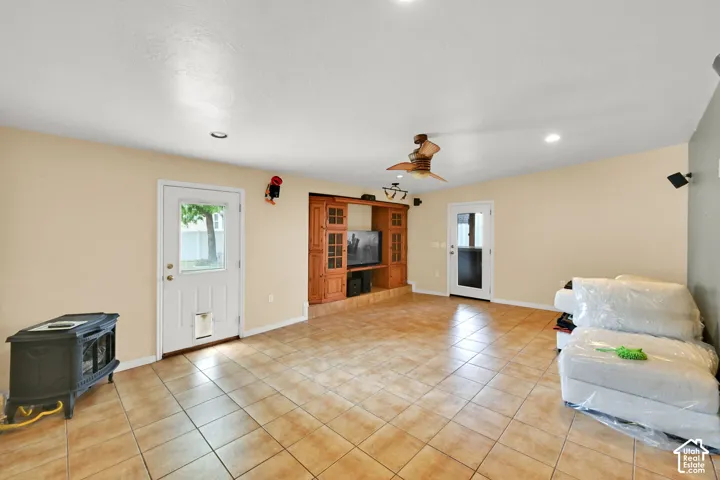 Main floor bonus rom. Tiled flooring, recessed lighting, ceiling fan, and built-in wood cabinetry