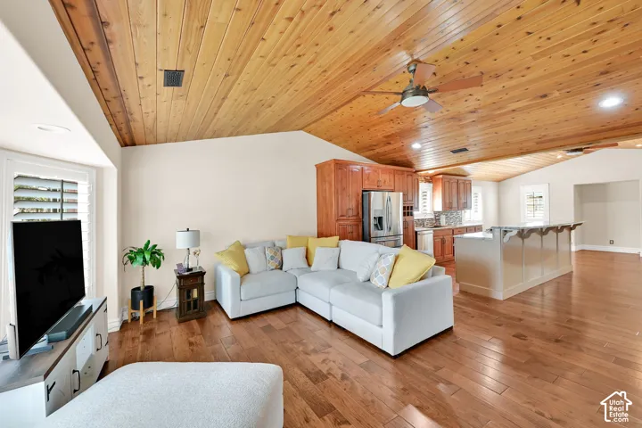 Vaulted wood-paneled ceiling, wood-finish flooring, custom wood cabinetry, and recessed lighting