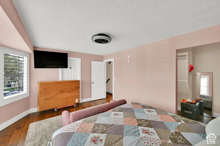 Primary bedroom, with walk-in closet, adjoining bathroom.