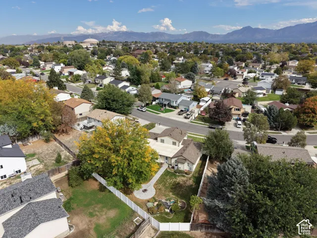 Aerial perspective showcasing a residential neighborhood with mountain backdrop