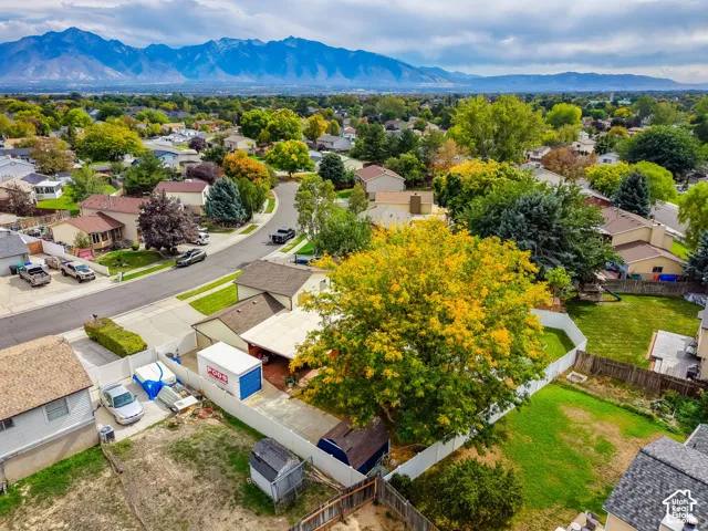 Residential neighborhood with established landscaping and mountain backdrop