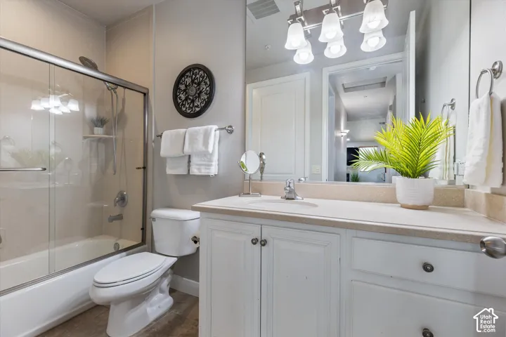 Bathroom: A full bath with a glass-door tub/shower and a vanity with storage.