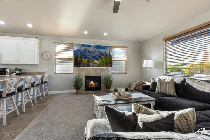 Living Room: A tiled gas fireplace anchors the living room, with big windows on one side and the breakfast bar on the other.