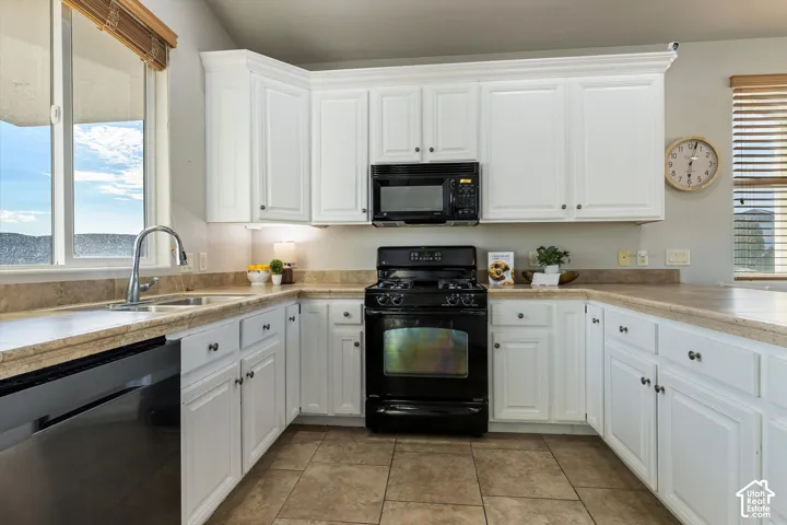 Kitchen: A gas range, built-in microwave, dishwasher, and a window over the sink.