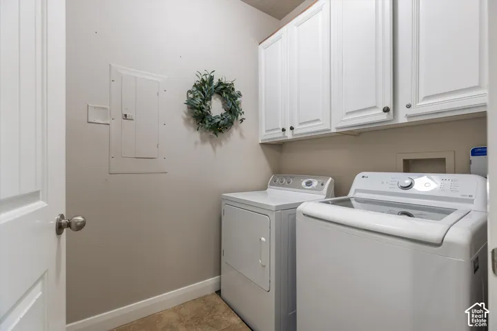 Laundry: A separate laundry room with upper cabinets and a washer and dryer.