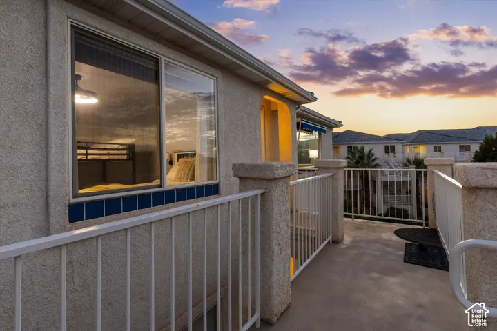 Exterior: The third-floor entry landing at sunset, looking out over the courtyard.