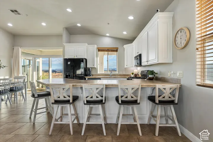 Kitchen: The breakfast bar wraps around the kitchen and opens to the dining area and deck views.