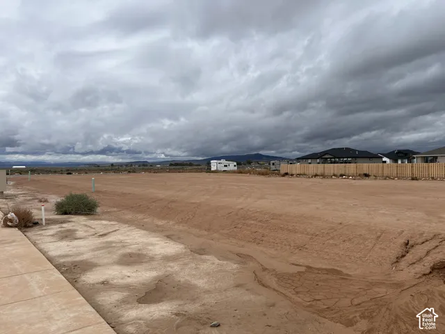 Level lot featuring concrete curbing and proximity to mountain scenery