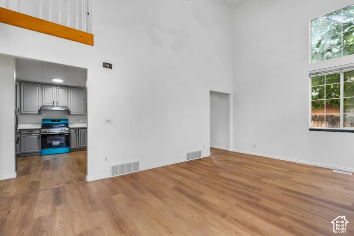 Vaulted ceilings, wood-finish flooring, and expansive windows