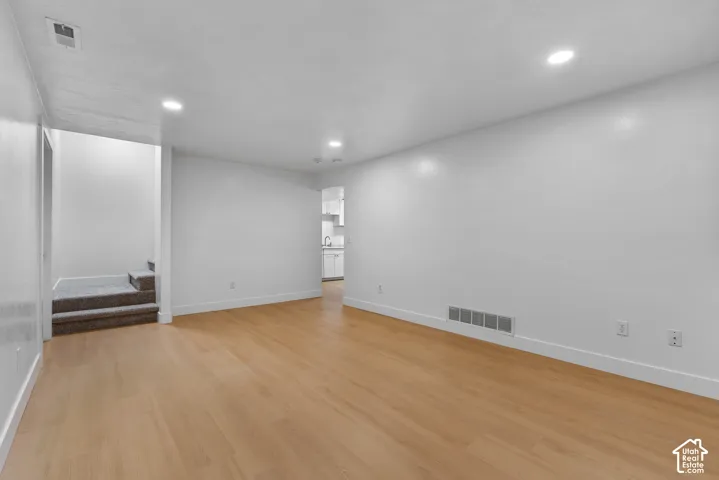 Interior space featuring wood-finish flooring, recessed lighting, and neutral wall paint