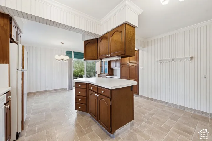 Kitchen featuring wood cabinetry, a central peninsula with solid-surface countertop, beadboard wall paneling, and tile flooring