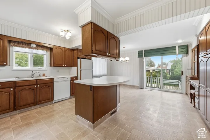 Kitchen featuring stained wood cabinetry, solid-surface peninsula countertop, beadboard wall paneling, tile flooring, and sliding glass doors