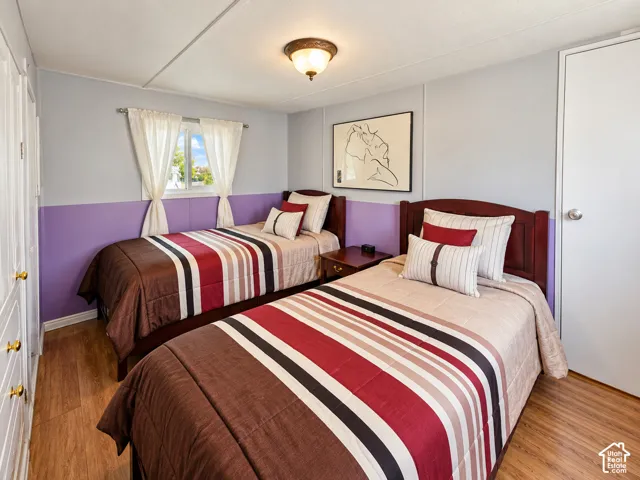 Wood-finish flooring, two-tone wall paint, dual-pane window, and a semi-flush mount ceiling fixture