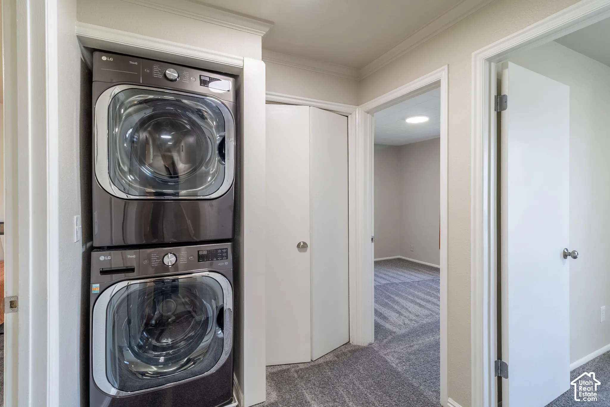 Stackable washer and dryer appliances within a dedicated alcove