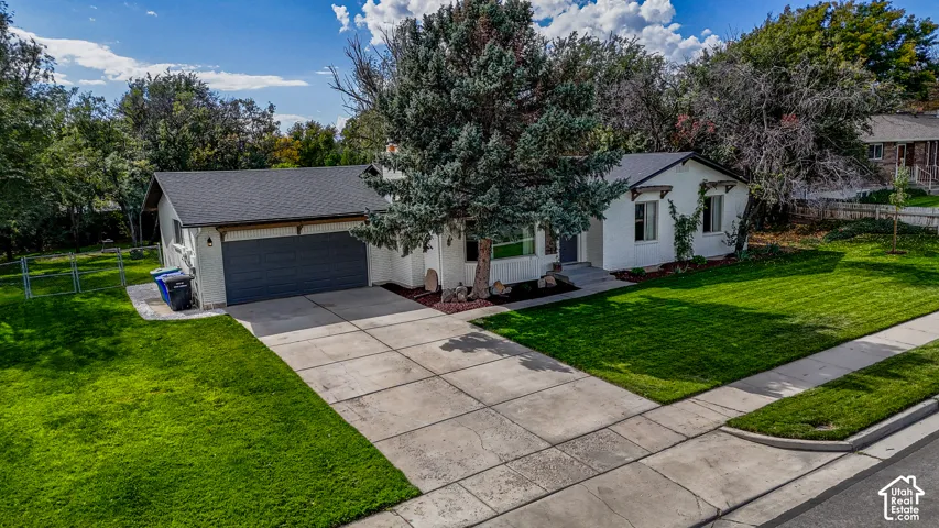 White exterior with dark trim and a prominent garage