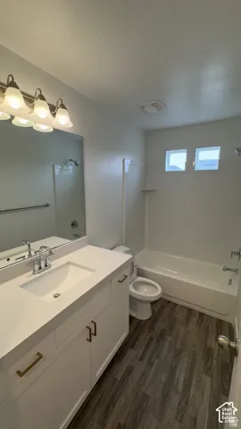 White vanity with gold-finish hardware, a white countertop, and a chrome faucet