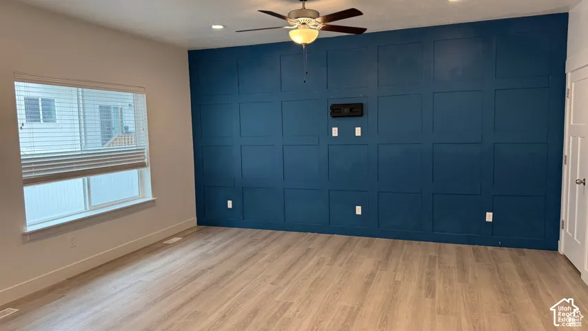 Accent wall featuring wainscoting and a built-in media mount