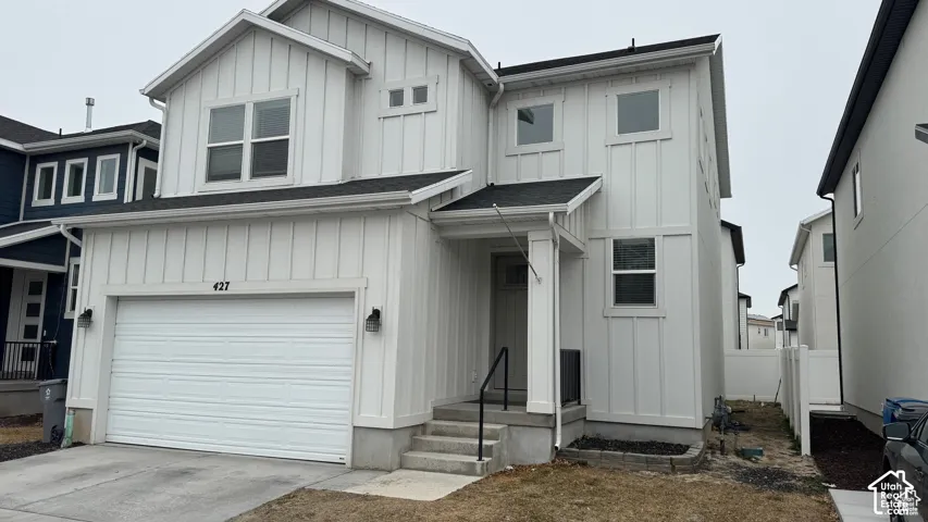White vertical plank siding exterior with a dark roof
