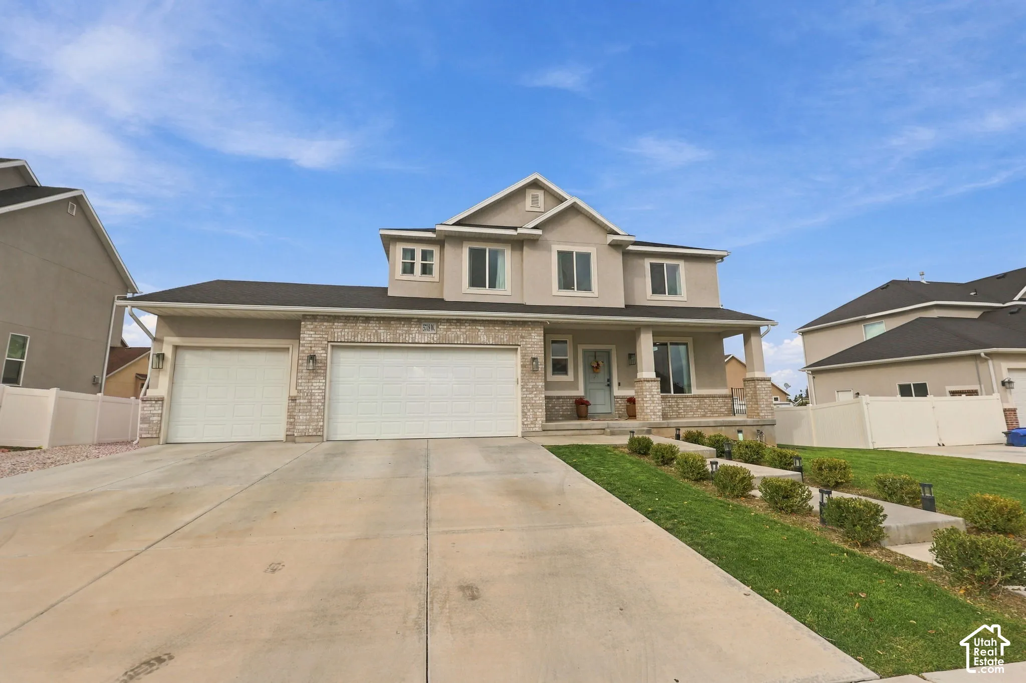 Two-story exterior featuring a stone and stucco fa