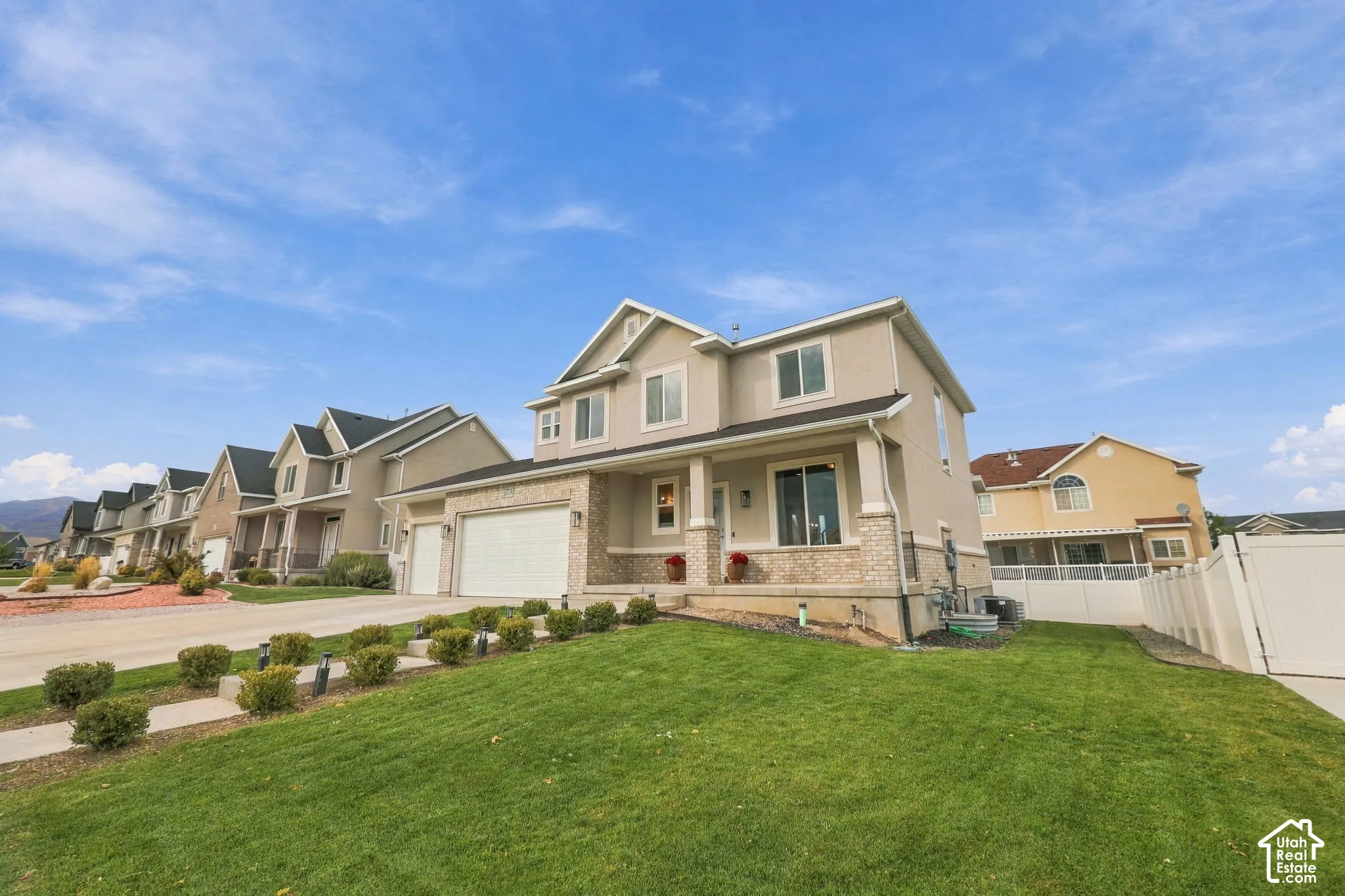 Two-story exterior featuring a stone and stucco fa