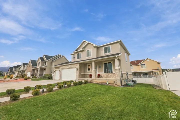 Two-story exterior featuring a stone and stucco fa