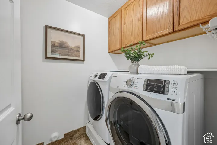 Laundry space featuring overhead wood cabinetry and tile flooring