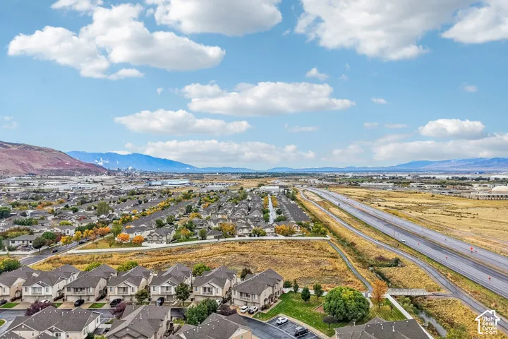 Aerial perspective featuring suburban residential development with mountain backdrops and expansive open terrain