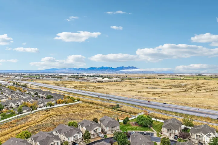 Aerial perspective featuring suburban residential architecture and distant mountain backdrops