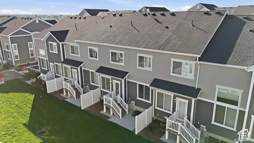 Townhome exteriors with gray siding, white trim, and dark gray shingle roofs