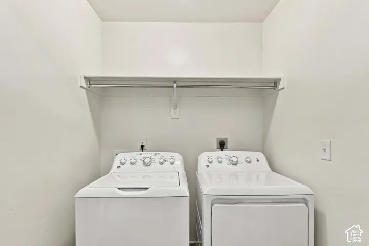 Laundry area with included washer & dryer plus a built-in shelf and hanging rod