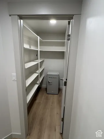 Space for a larger fridge and outlet for a microwave plus abundant shelving