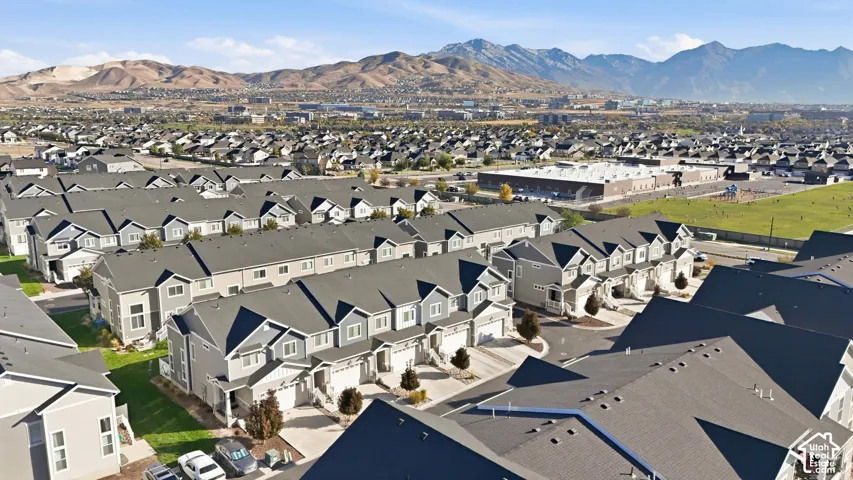 Modern townhome development with gray siding and prominent mountain backdrop