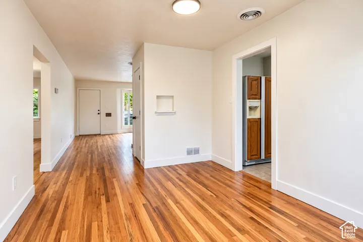 Interior space featuring wood-finish flooring, a recessed wall niche, and flush-mount ceiling lighting