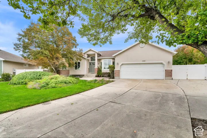Single-story exterior featuring a light-toned stucco fa