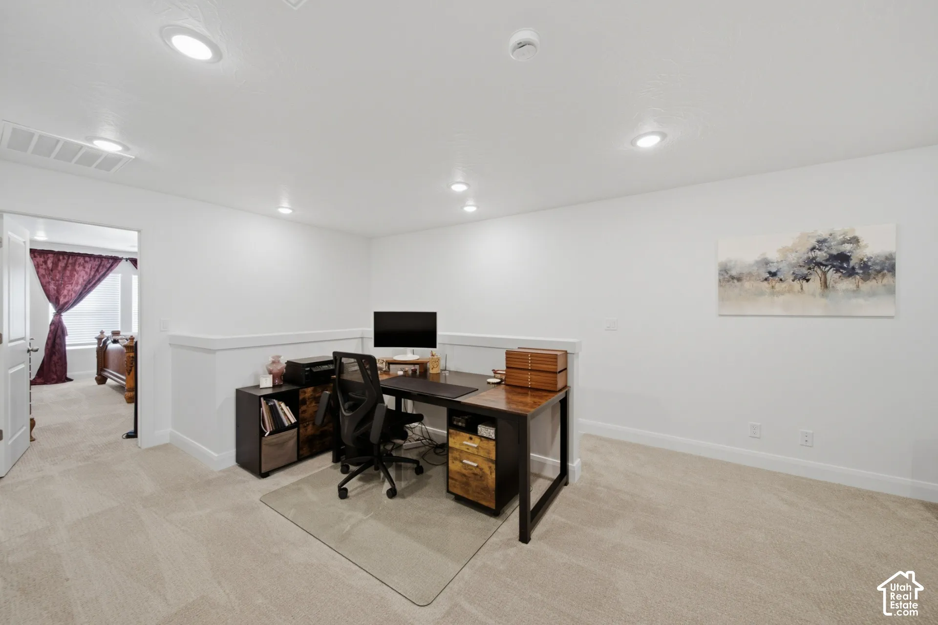 Open room featuring neutral carpeting, recessed ceiling lighting, and a half-wall partition with a ledge