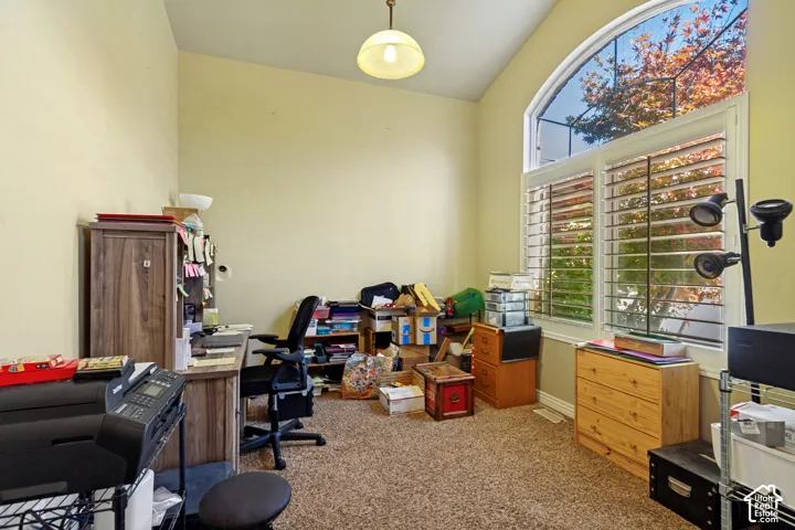 Arched transom window above a large window with plantation shutters
